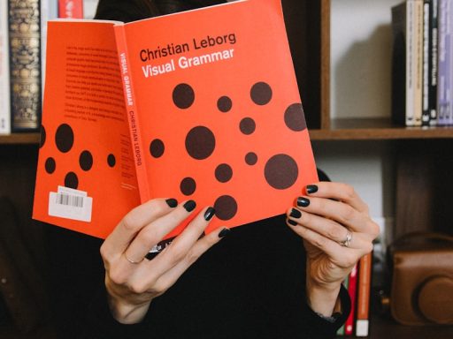 person holding orange and white polka dot paper